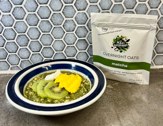 Bowl of matcha overnight oats with a package of Matcha Overnight Oats on a countertop.