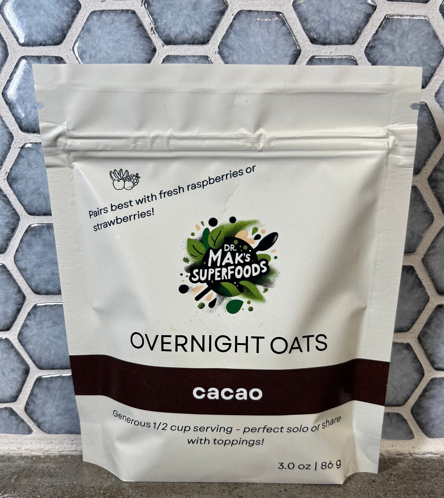 Package of Dr. Mak's Superfoods Overnight Oats cacao flavor on a textured surface.